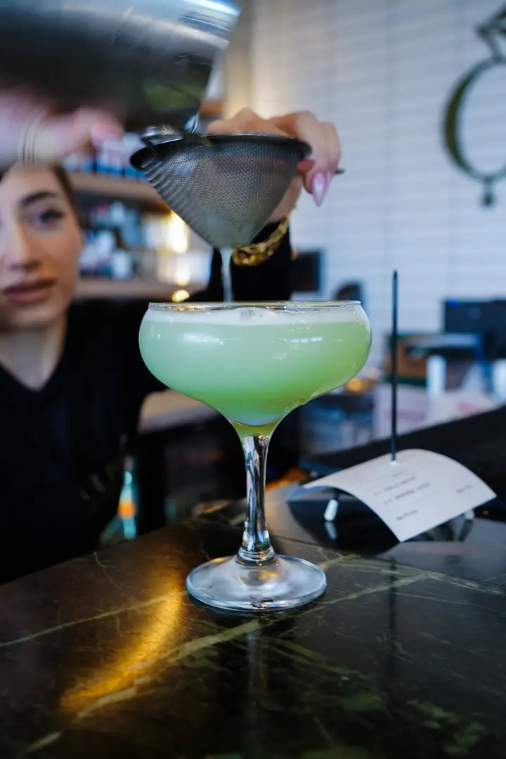 A cocktail being made at the bar