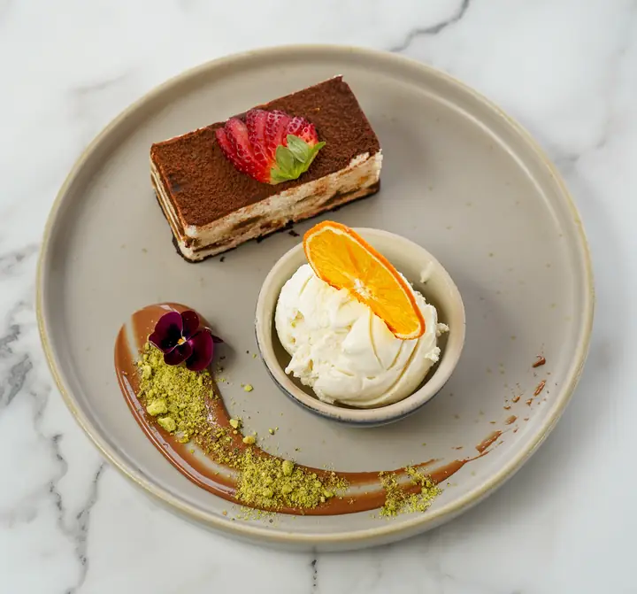 A plated dessert with cream