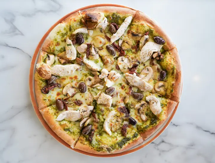 Pizza topped with avocado