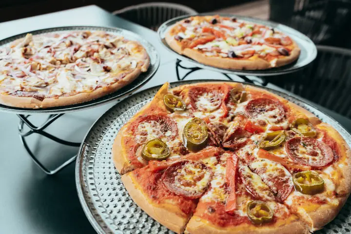 Pizzas shared across a table